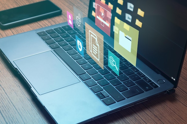Photo laptop with management document icons for data management system concept documentation database