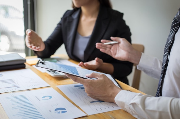Midsection of couple holding hands on table