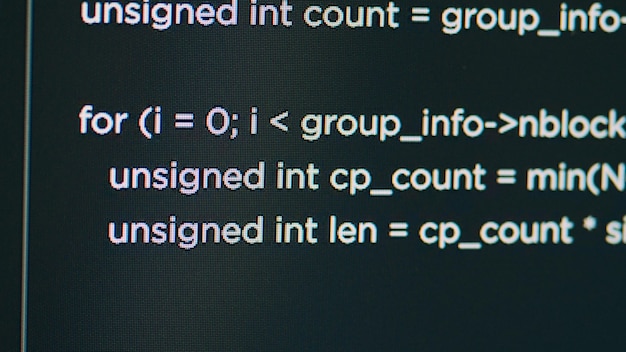 Photo monitor display of system engineer typing source code on terminal window, creating software app with html script. concept of software developer writing programming language. close up.