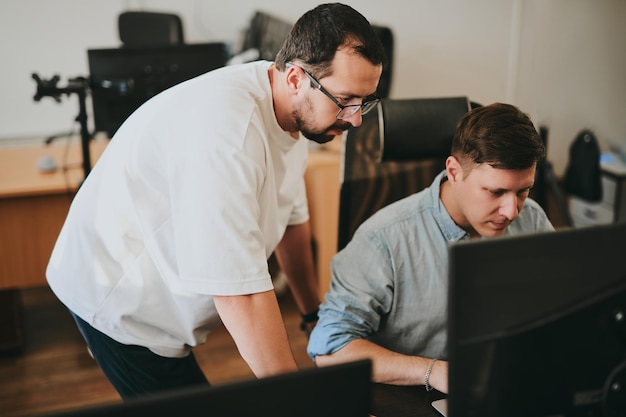 Photo portrait of two professional male programmers working on computer in diverse offices modern it technologies development of artificial intelligence programs applications and video games concept