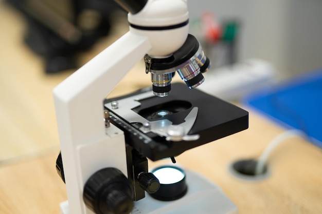 Photo professional microscope in a school laboratory for the study of cells and bacteria