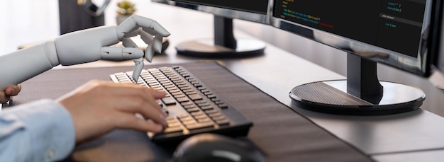 Photo program coding automation by generative artificial intelligence or ai concept collaboration between robotic hand and human software developer solving debugging or writing scripttrailblazing