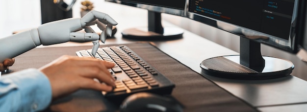 Photo program coding automation by generative artificial intelligence or ai concept collaboration between robotic hand and human software developer solving debugging or writing scripttrailblazing