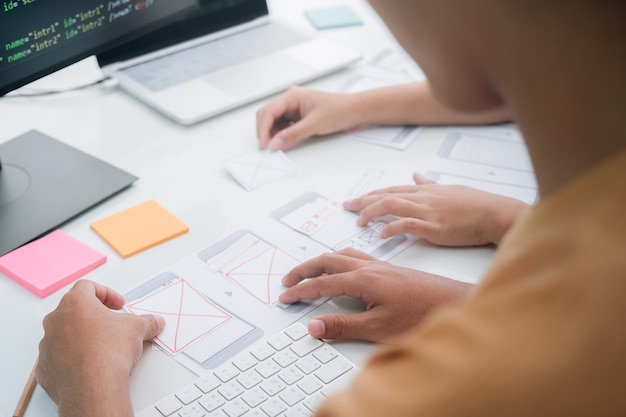 Photo programmer and ux ui designer working in a software development and coding technologies. app design and programming development technology.