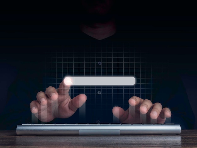 Photo searching icon on search engine bar pointing by man's finger while using computer keyboard with network background. blank search tab. searching browsing internet data information networking concept.