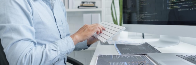 Photo software development concept male programmer using keyboard to typing data codes on computer