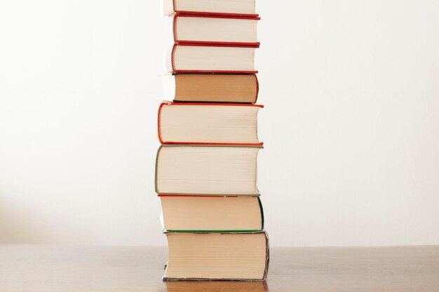 Photo stack of books on table against white background
