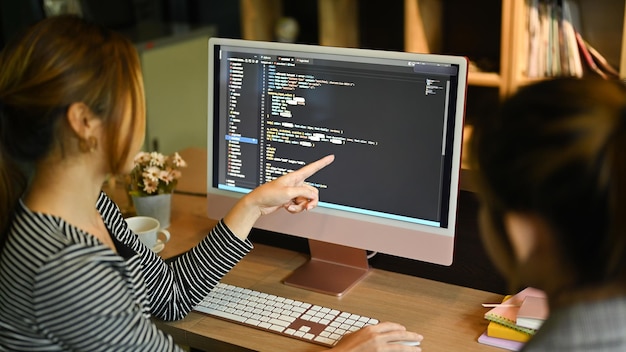 Photo team of software development brainstorming working with coded data in corporate office programming and coding technologies concept