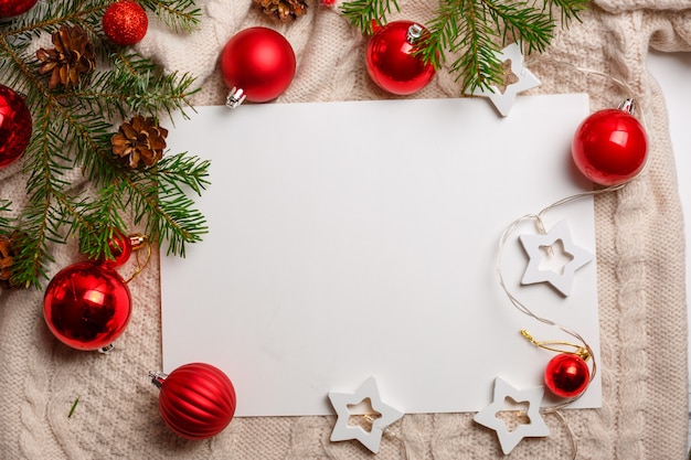 Photo top view christmas decoration with blank paper sheet