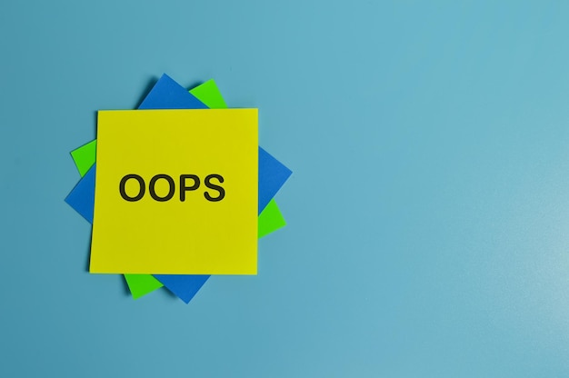 Photo top view of colorful paper notes written with oops stands for object oriented programming system copy space