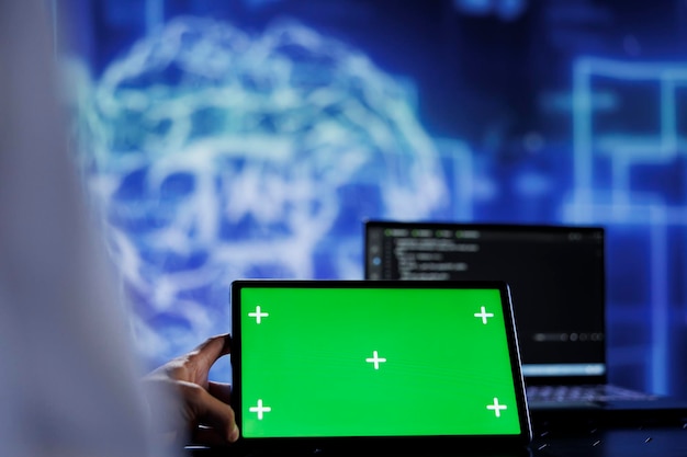 Photo trained admin writes code on mockup tablet to visualize artificial intelligence neural networks using augmented reality. high tech workspace worker runs ai script on isolated screen device