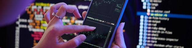 Photo using tablet for analyzing financial data in dark room