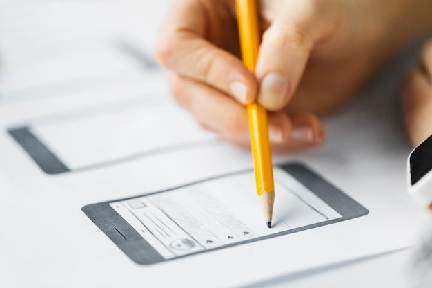 Photo web designer hand creating user interface layout