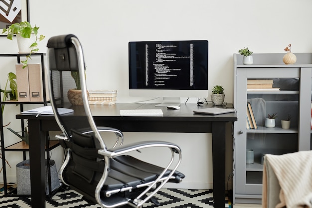 Photo workplace of computer programmer with new software on computer monitor at office