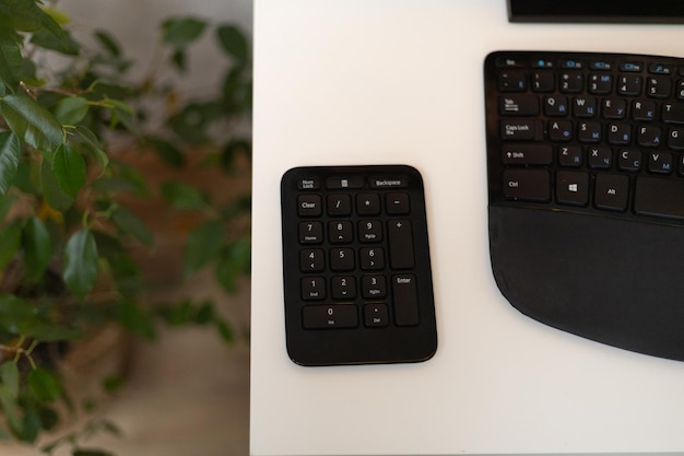 Photo workspace calculator and keyboard on white desktop surface