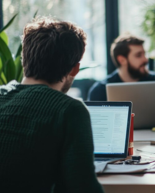 Photo a workspace scene with individuals collaborating and using laptops in a modern environment