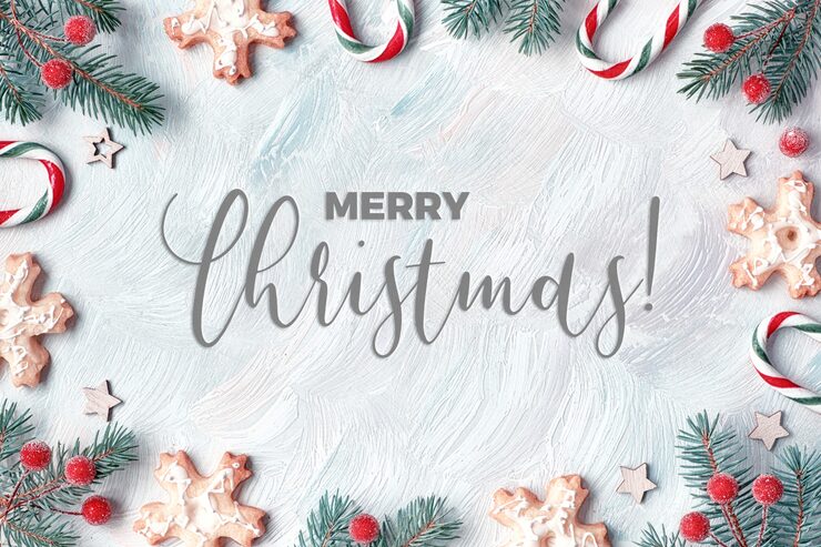 Photo xmas frame with fir twigs, candy canes, frosted berries and cookies. light textured , flat lay with text "merry christmas".