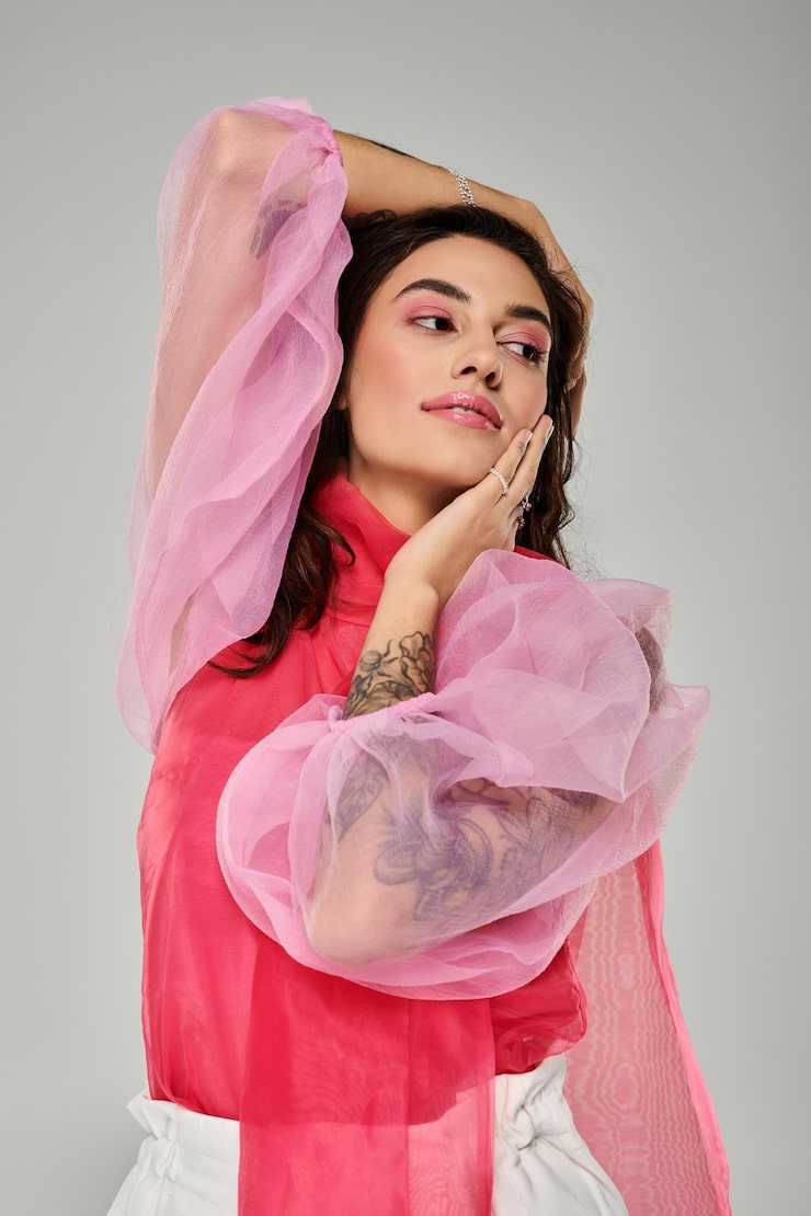 Young beautiful woman posing gracefully with stylish attire in a studio setting