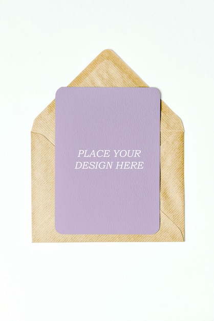 PSD brown envelope opened with purple paper inside psd mockup