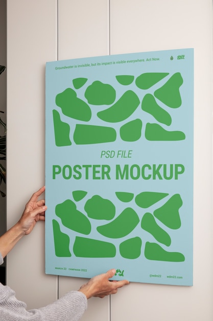 PSD person holding poster mockup