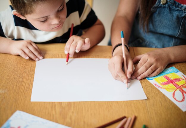 PSD sister and brother drawing at a table