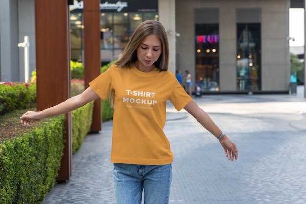 PSD t-shirt mockup girl walking in modern city
