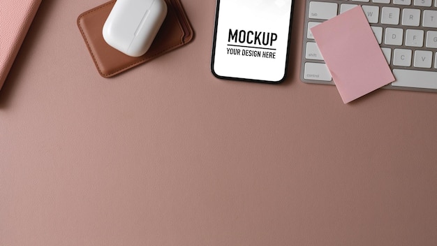 PSD top view of computer desk with smartphone mockup