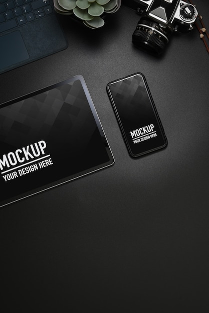 PSD top view of workspace with tablet, smartphone, camera mockup