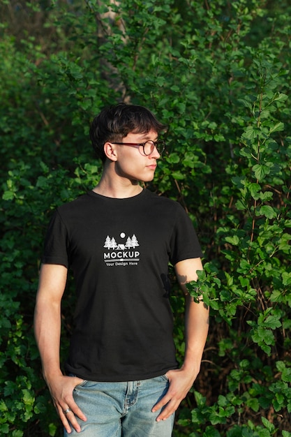 PSD young man wearing a mock-up t-shirt in the nature